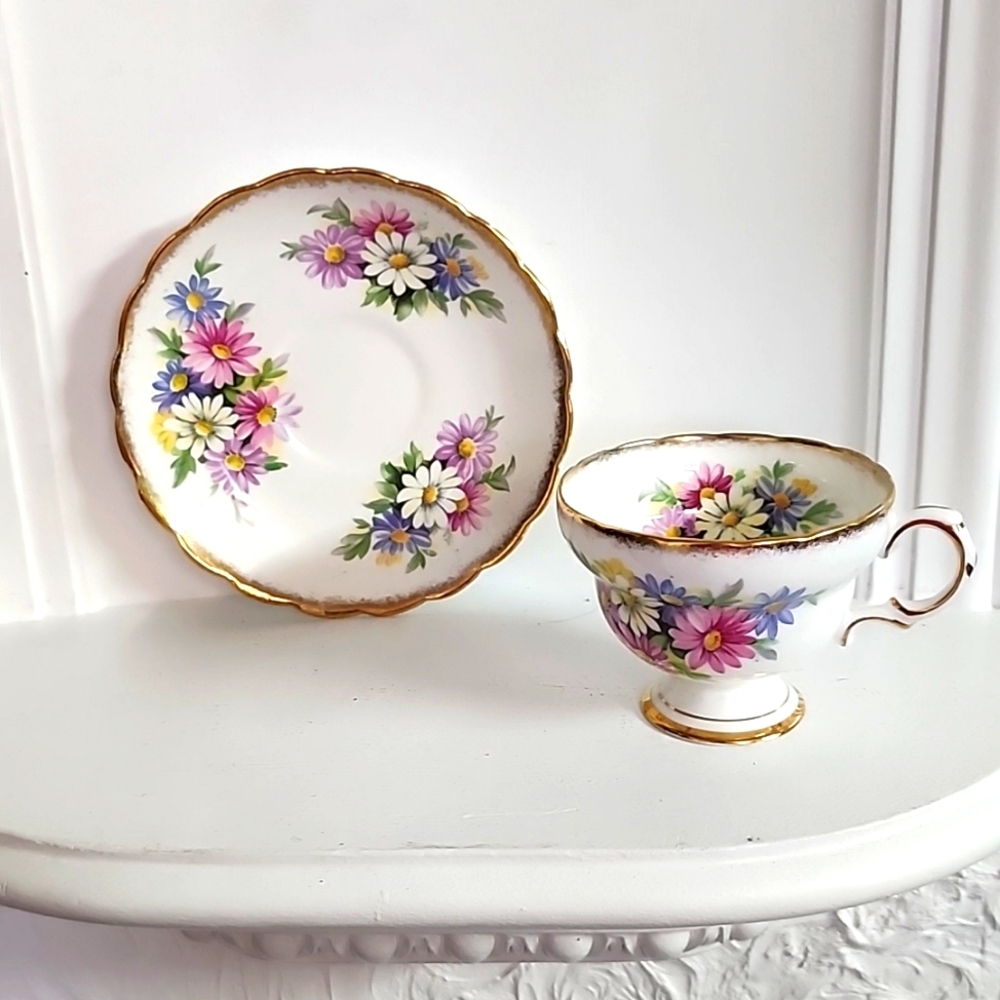 Pretty Rosina Teacup and Saucer Duo Accentuated with Daisies and Heavy Gold Bord